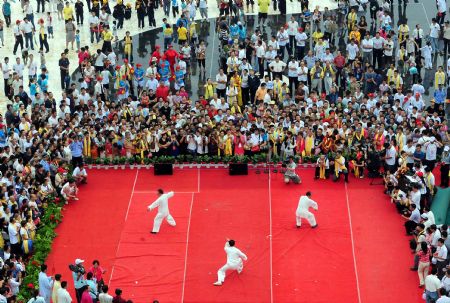 Three practitioners perform Taiji in a stage in this photo taken on Aug. 21, 2009 in Wenxian county of central China's Henan Province. Chenjiagou village in the county, the birth place of Chen style Taiji, one of most famous Chinese internal martial arts, is among the most favored destinations for the tourists in the province.(Xinhua/Wang Song)