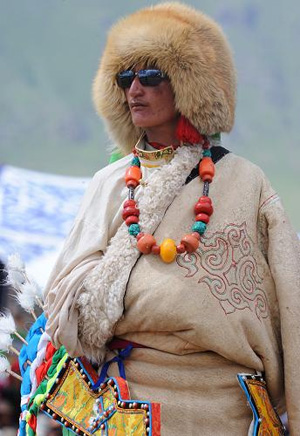   A herdsman from Damxung Nyemo County, Lhasa, displays a traditional Tibetan-style sheepskin coat during a horse racing festival on Aug.21, 2009. 